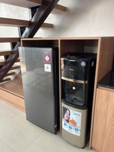 a refrigerator sitting in a kitchen next to a shelf at Villa with Jacuzzi, Damar Ningrum 4 in Tutugan