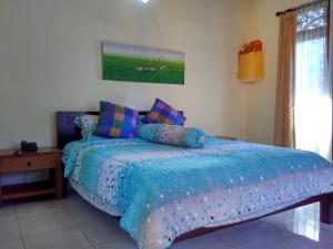 Postel nebo postele na pokoji v ubytování Rusma House Ubud