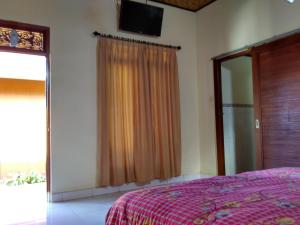 Postel nebo postele na pokoji v ubytování Rusma House Ubud