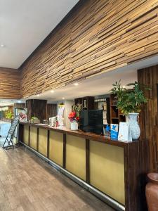 a lobby with a long counter with plants on it at Ion Bali Benoa in Nusa Dua +106 photos