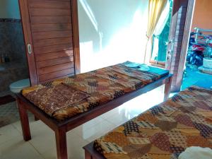 Postel nebo postele na pokoji v ubytování Rusma House Ubud