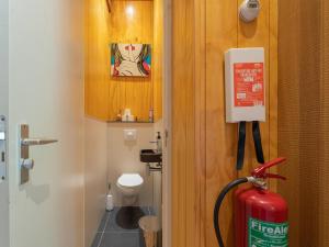 a bathroom with a fire hydrant next to a toilet at Cottage in Dwingelderveld with Scenic Views in Beilen +33 photos