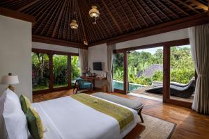 a bedroom with a bed and a view of a garden at Nau Villa Ubud in Tegalalang +58 photos