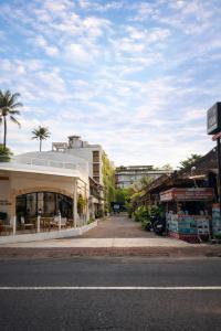 an empty city street with buildings and palm trees at Ion Bali Benoa in Nusa Dua