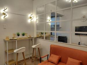 a living room with a couch and a table and chairs at SMDC Trees Residences Jim's Staycation in Manila