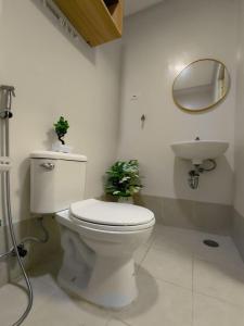 a bathroom with a toilet and a sink at SMDC Trees Residences Jim's Staycation in Manila