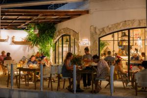 a group of people sitting at tables in a restaurant at Ion Bali Benoa in Nusa Dua