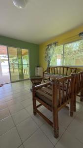 a room with two wooden benches on a tile floor at Bantayan Beachfront Seacamp Okoy Private House Operated by In Dai Aquasports and Beach Resort in Bantayan Island