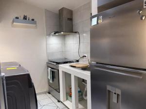 a small kitchen with a stove and a refrigerator at Casa Pradera in Manuel F. Martínez