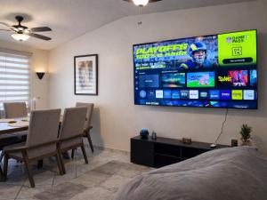 a living room with a large screen on the wall at Casa Pradera in Manuel F. Martínez