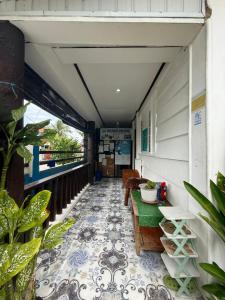 a balcony with a table and chairs on a tile floor at Couple Room by Burication Homestay in General Luna