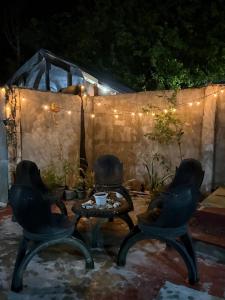 a patio with two chairs and a table and lights at Couple Room by Burication Homestay in General Luna