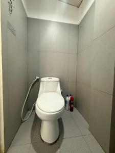 a bathroom with a white toilet in a stall at Couple Room by Burication Homestay in General Luna