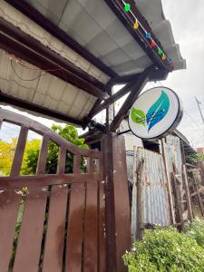 a sign on a wooden fence with a sign on it at Couple Room by Burication Homestay in General Luna +1 photo