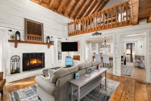 a living room with a couch and a fireplace at Kingfisher's Cabin 15 Minutes to Casino Hot tub Firepit in Murphy