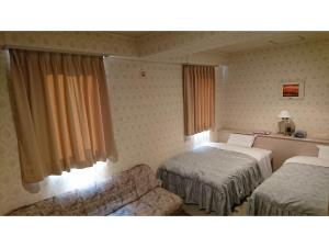 מיטה או מיטות בחדר ב-Hotel Muroran Hills