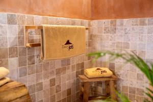 a bathroom with a towel with the words fire hut on it at Taman Jati in Gili Islands +25 photos