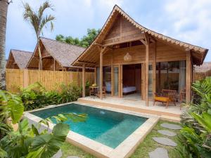 an image of a villa with a swimming pool in front of it at Taman Jati in Gili Islands