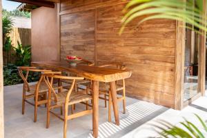 a wooden table and chairs on a patio at Taman Jati in Gili Islands