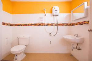 a bathroom with a toilet and a sink at Satakanta Resort Lampang in Ban Nong Chaeng