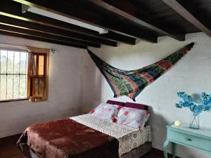 a bedroom with a bed with a hammock on the wall at Casa Campestre Familiar in Medellín +40 photos