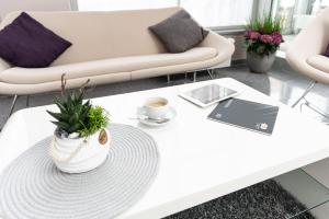 a white coffee table in a living room with a couch at elaya hotel wolfenbuettel, Trademark Collection by Wyndham in Wolfenbüttel