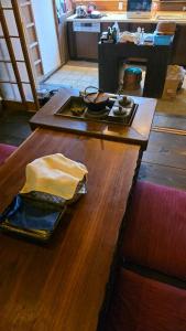 a wooden table with a napkin on top of it at ゲストハウス　竹亭 in Marugame