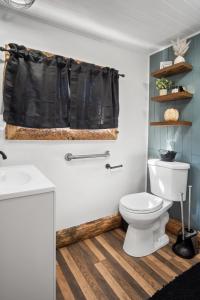 a bathroom with a toilet and a black shower curtain at Valley View Hideaway Cabin with Mountain Views in Miramonte +17 photos