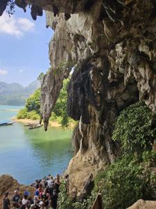 a group of people standing in front of a mountain at Bingo Hostel Khao Sok in Khao Sok National Park