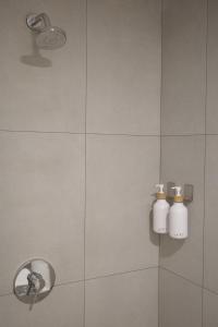 a bathroom with two soap bottles on the wall at Una Hotel in Mantaak +22 photos