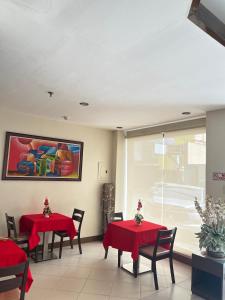 a dining room with red tables and chairs at Olive Suites in Cagayan de Oro