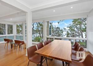 a dining room with a table and chairs at Angels Little Haven in Cams Wharf