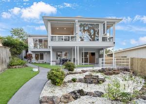 a large white house with a garden in front of it at Angels Little Haven in Cams Wharf