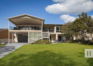 a large house with a lawn in front of it at Enjoy Lazy Daze in Summerland Point