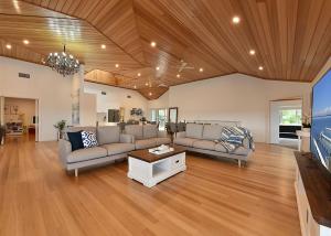 a living room with two couches and a table at Lake Daze at Coal Point in Coal Point