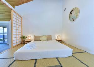 a bedroom with a bed and a clock on the wall at Lake Daze at Coal Point in Coal Point +31 photos