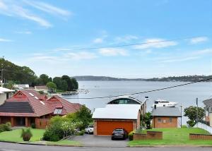 a view of a house with a lake in the background at Lake Daze at Coal Point in Coal Point