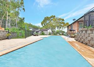 an empty swimming pool in a yard with a fence at Lake Daze at Coal Point in Coal Point