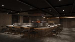 a long bar in a room with a row of chairs at Gensen Itto Minamiizu in Minamiizu