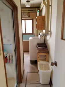 a small bathroom with a sink and a refrigerator at 80s stay 釧路 in Kushiro +40 photos