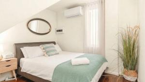 a small bedroom with a bed and a mirror at New York Style Apartment in Bendigo
