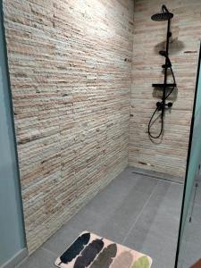 a bathroom with a shower and a rug at Villa Claudine in Ambengan