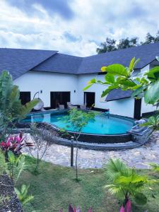 a swimming pool in the backyard of a house at Villa Claudine in Ambengan