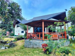 a house with a gazebo in the yard at Villa Claudine in Ambengan +12 photos