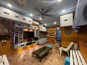 a living room with a couch and a table at X Rector Finest in Tioman Island
