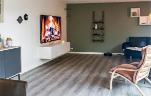 a living room with chairs and a painting on the wall at Awesome Home In Thyborøn With Wifi in Thyborøn
