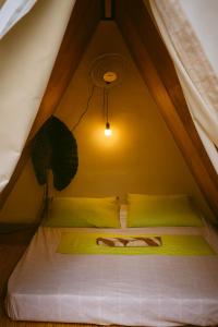 a bedroom with a bed in a tent at Kapsula El Nido in El Nido +13 photos