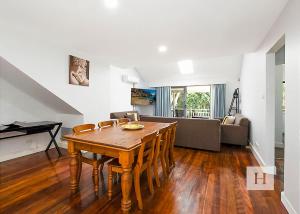 a living room with a table and a couch at Lakeshores Villa in Cams Wharf