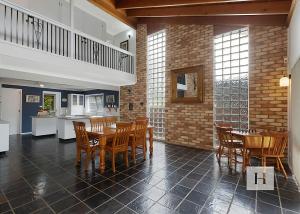 a kitchen and dining room with a table and chairs at Mannering Lake House in Mannering Park