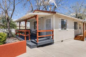 a tiny house with a porch and a deck at Old Town Cottonwood Cottage in Cottonwood